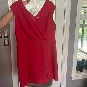 Mid thigh red dress with button detail. Zipper in back. Poly-rayon blend
